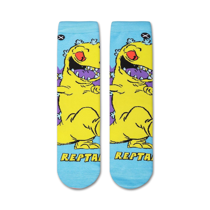 Flat lay showcasing a pair of Rugrats Reptar socks, highlighting the full design.