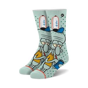 Crew socks in teal and white featuring Squidward Tentacles from Spongebob Squarepants. He's in his work uniform, holding a notebook, on a teal background with white polka dots.