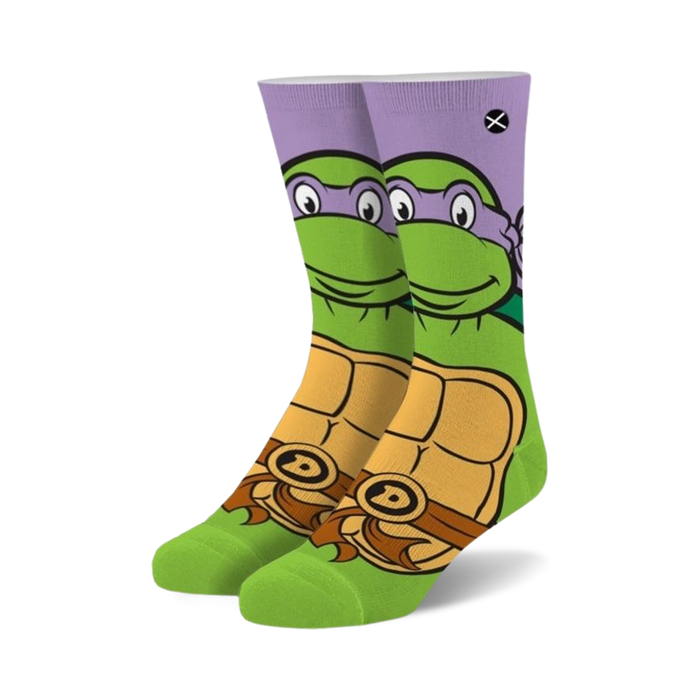Pair of crew socks featuring Donatello from TMNT.  Purple, green, and orange design with Donatello's face and shell.