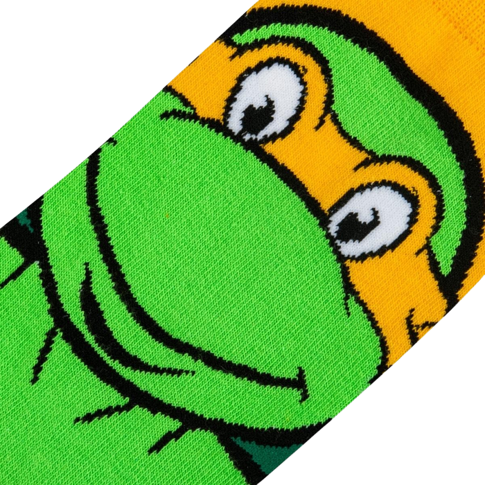 Close-up detail shot of Michelangelo's face on the TMNT crew socks, showing the texture and quality of the print.
