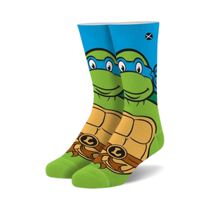Crew socks in green, blue, and orange. Feature Leonardo from TMNT, his face on the top and his shell on the bottom.