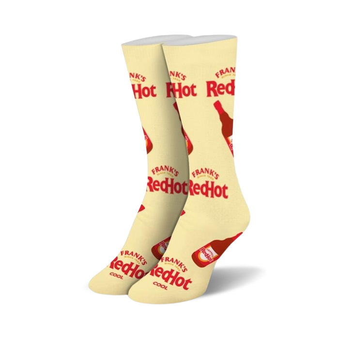Pair of cream-colored crew socks with repeating Frank's RedHot logo and bottle illustrations. Red and cream color scheme.