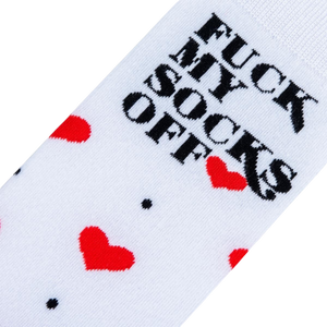 Close-up detail shot of the sock's playful design: red hearts and the phrase 'Fuck My Socks Off'.