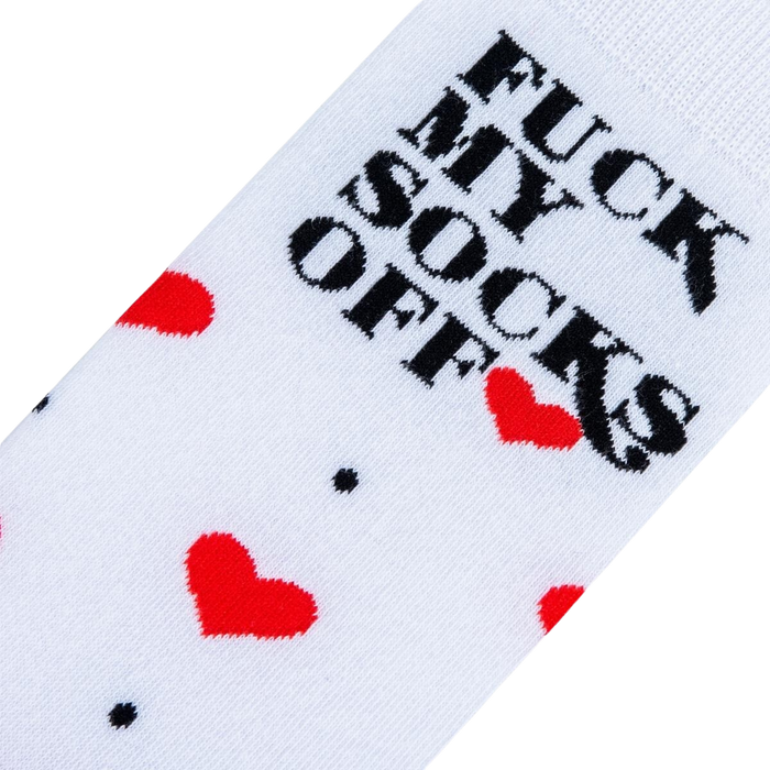 Close-up detail shot of the sock's playful design: red hearts and the phrase 'Fuck My Socks Off'.