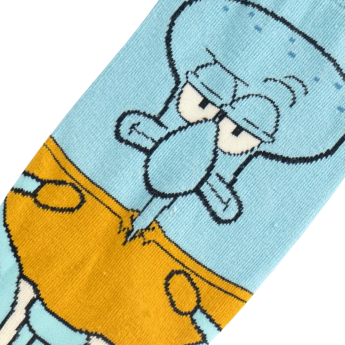 A blue sock with a cartoon character, Squidward Tentacles from Spongebob Squarepants, on the leg. Squidward is wearing his iconic brown pants with a white belt and has his signature grumpy expression on his face.