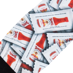 Close-up detail shot of the Tapatio hot sauce packet pattern on the socks.