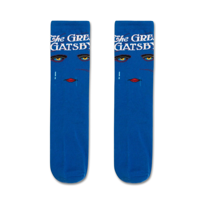 Pair of blue crew socks with an Art Deco design. The socks feature a woman's face with gold eyes and red lips, along with the text 'The Great Gatsby'. }}
