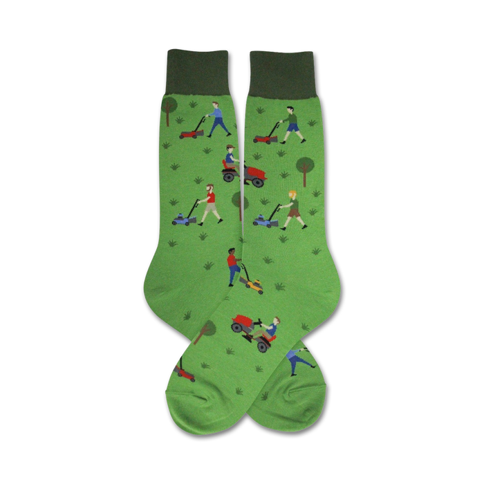 Pair of green crew socks with a pattern of people mowing lawns on riding and push mowers.  The socks have dark green cuffs. }}