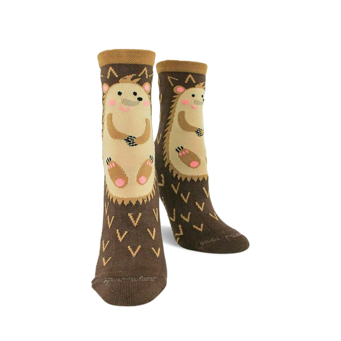 Pair of brown crew socks with a beige hedgehog design. The socks have a non-skid bottom and small 'V' shapes. }}