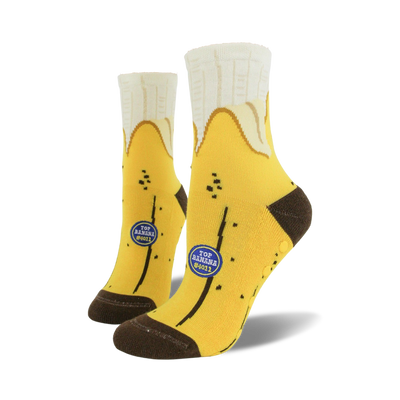 Pair of yellow banana-themed non-skid slipper socks. Brown heel and toe. Features small blue logo that says 'Top Banana #4011'.
