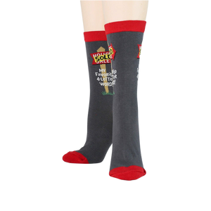 A pair of gray socks with red toes, heels, and tops. The socks have the words 