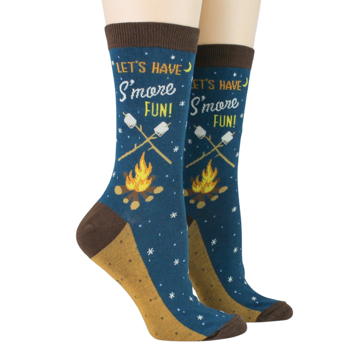 Pair of 'Let's Have S'more Fun!' socks on a model's feet against a black background.