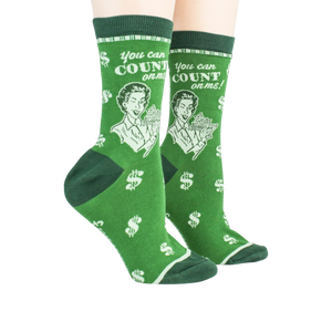 Lifestyle shot showing a pair of green 'Accountant' socks on a person's feet.