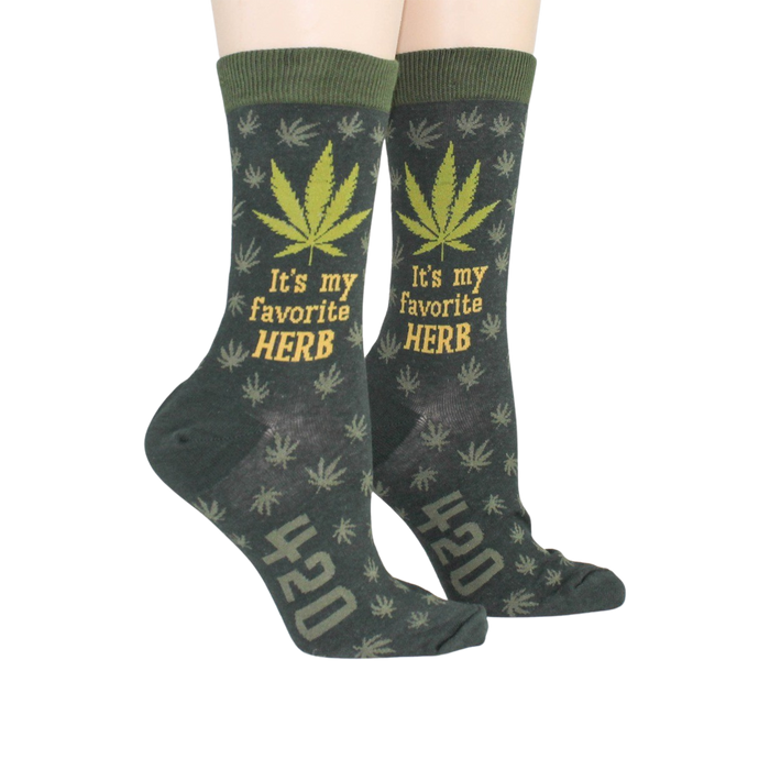 Lifestyle shot of a person wearing the green marijuana socks, showcasing how they look when worn.
