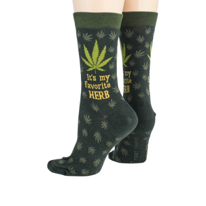 Close-up flatlay showcasing the detail of the marijuana leaf socks, highlighting the 'It's my favorite herb' text and '420' detail.