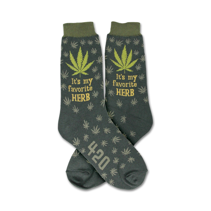 Crew socks in dark green with a repeating marijuana leaf pattern.  'It's my favorite herb' and '420' are featured on the socks.
