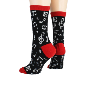 Back view of 'Dancing Notes' socks on a model's feet, showing the red cuff detail.