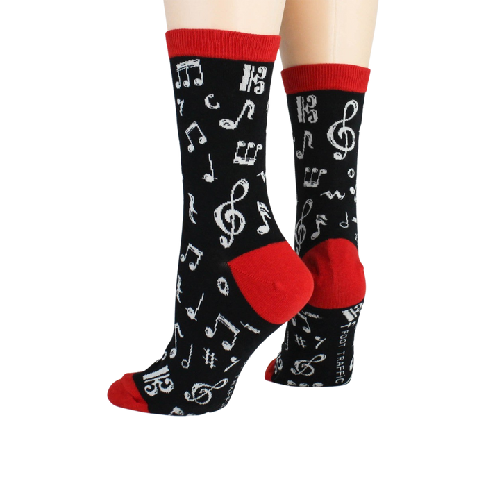 Back view of 'Dancing Notes' socks on a model's feet, showing the red cuff detail.