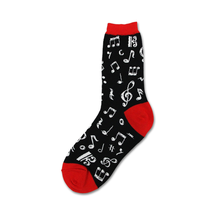 Close-up of a black crew sock with white musical notes and a red cuff.  'Dancing Notes' sock design.