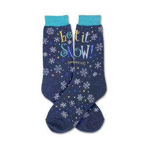 Pair of navy blue crew socks with a snowflake and star pattern and the text 'Let It Snow!' in yellow, blue, and white.
