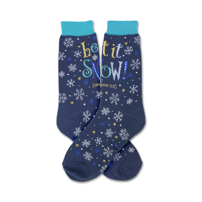 Pair of navy blue crew socks with a snowflake and star pattern and the text 'Let It Snow!' in yellow, blue, and white.