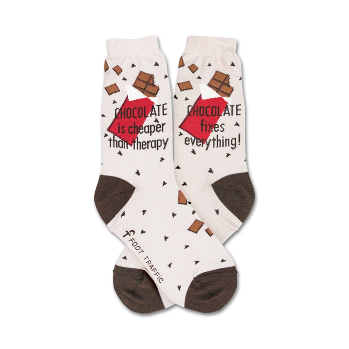 Cream crew socks with brown heel and toe. Features chocolate bar graphics and the text 'Chocolate is cheaper than therapy' and 'Chocolate fixes everything!'