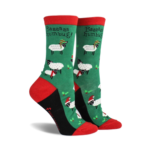 Pair of women's crew socks. Green background with festive sheep wearing Santa hats and scarves. Red and black accents.