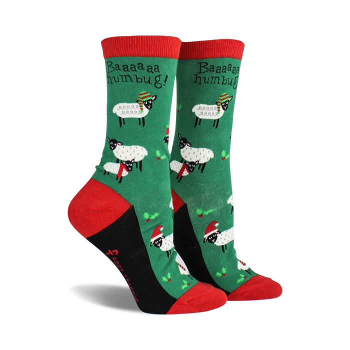 Pair of women's crew socks. Green background with festive sheep wearing Santa hats and scarves. Red and black accents.