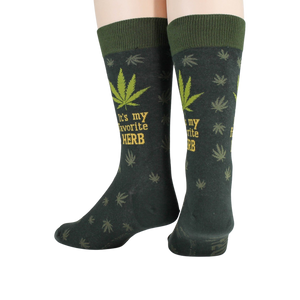 Close-up detail shot of the marijuana leaf and 'It's my favorite herb' text on the socks.