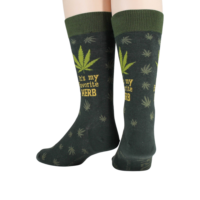 Close-up detail shot of the marijuana leaf and 'It's my favorite herb' text on the socks.