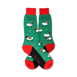 Flatlay showcasing a pair of green Christmas sheep socks with red and black accents.