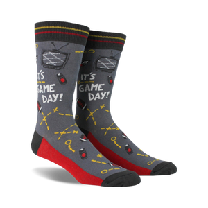 Pair of crew socks in gray, red, and navy blue. Design includes retro TV, game controllers, and the text 'It's Game Day!'
