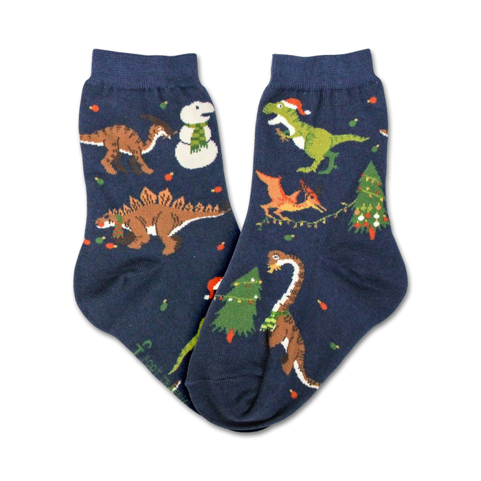 Pair of navy blue crew socks featuring a whimsical Christmas design with dinosaurs, snowmen, and Christmas trees. }}