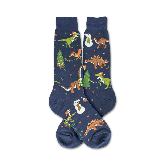 Flat lay showcasing the full design of the navy blue crew socks; Christmas dinosaurs and snowmen.