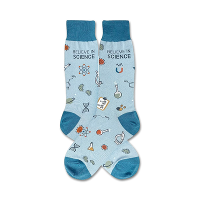 Pair of light blue crew socks with teal cuffs. The socks are adorned with science-themed illustrations: atoms, beakers, DNA strands, and the phrase 'Believe in Science'.