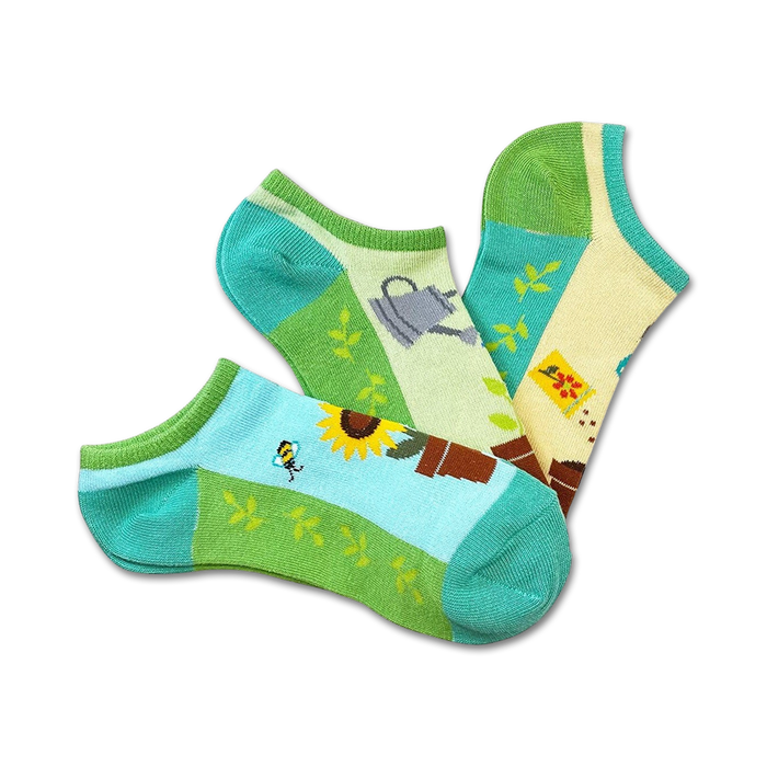 blue, green, and yellow no-show socks featuring sunflowers, bees, watering cans, and gardening tools.   }}