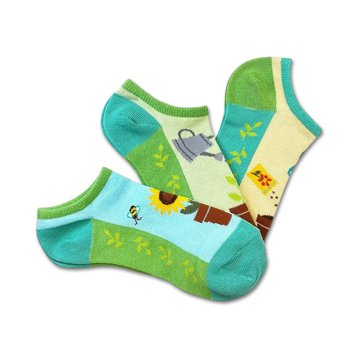 Three ankle socks in a 3-pack. Designs include sunflowers, watering cans, and gardening tools on a pastel green, yellow, and blue background. }}