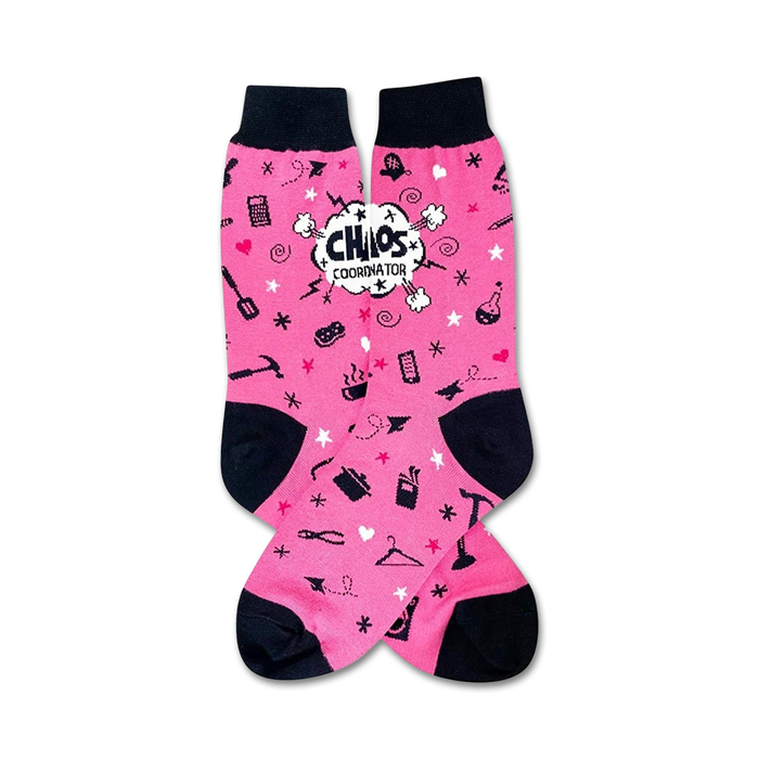 pink crew socks feature black toes and heels, repeating patterns of clothes irons, scissors, measuring tape, and a hanger. 