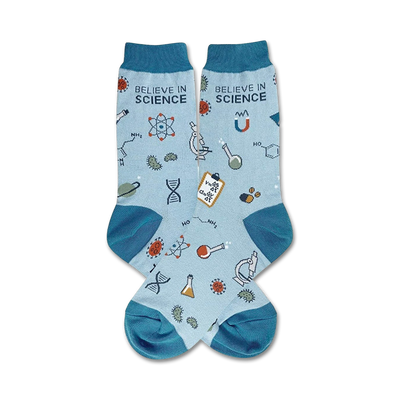 Pair of light blue crew socks with teal cuffs. Features science-themed illustrations: atoms, beakers, DNA strands, and the text 'Believe in Science'.