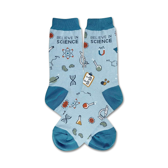 Pair of light blue crew socks with teal cuffs. Features science-themed illustrations: atoms, beakers, DNA strands, and the text 'Believe in Science'. }}