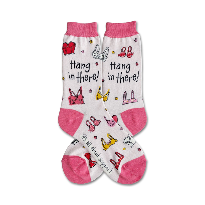 A pair of women's crew socks in white with pink accents. They feature colorful bras and the text 'Hang in there!' }}