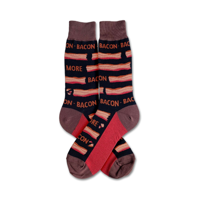 A pair of crew socks with a bacon pattern. The socks are mainly dark brown with red and tan stripes and text that says 'More Bacon'.