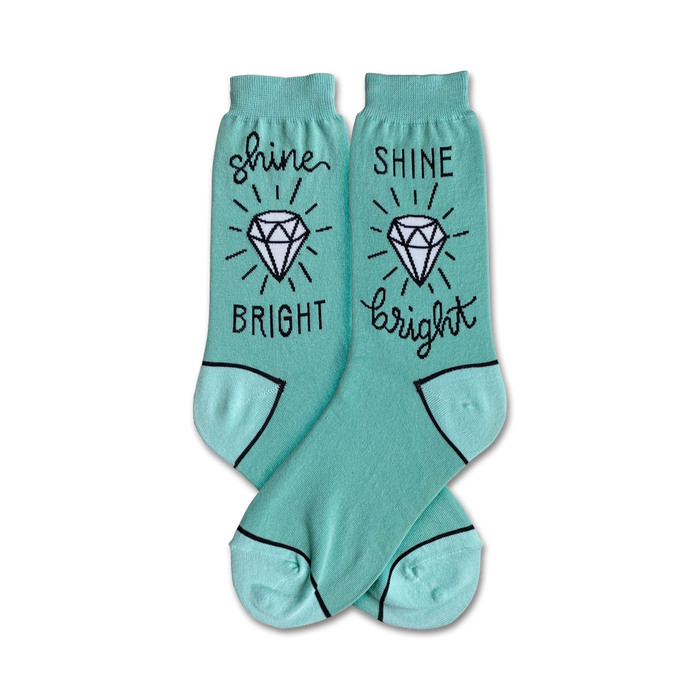 Pair of teal crew socks with a white diamond and 'Shine Bright' text in black. Fun, sparkly design! }}