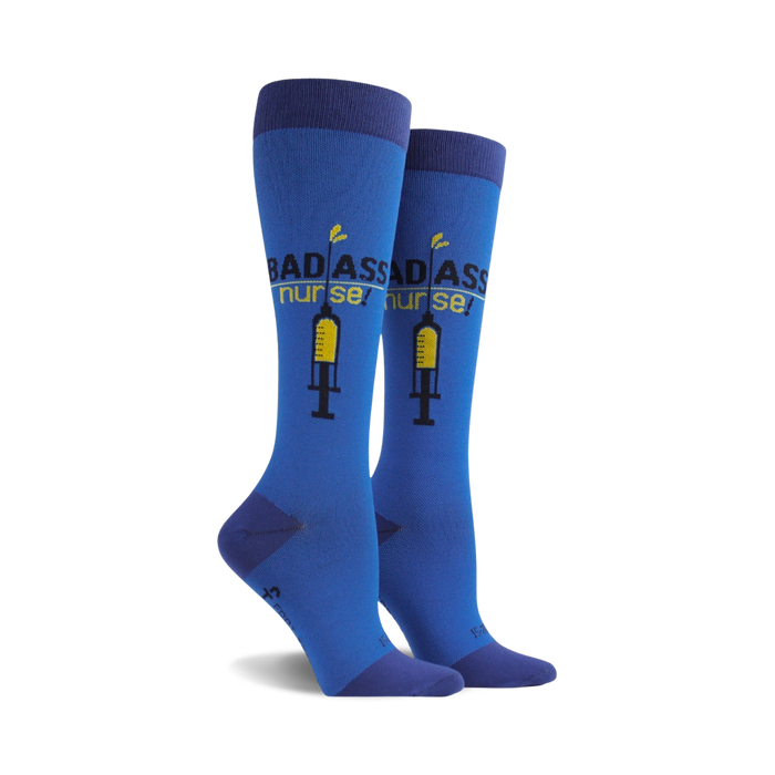 Pair of women's knee-high socks in blue.  The socks feature a graphic of a syringe and the text 'Badass Nurse!' in yellow and black. }}