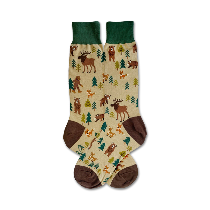 Pair of beige crew socks with brown, green, and dark-brown accents. Features illustrated woodland creatures like bears, moose, and foxes. }}