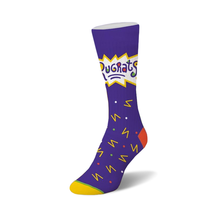rugrats confetti socks for women. purple with yellow toe and heel. crew length sock features rugrats cartoon characters and shapes in yellow, orange, blue, and green.     }}