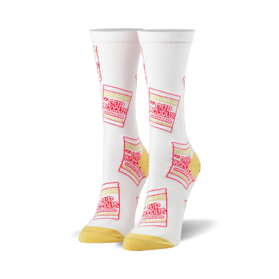 White crew socks with a repeating pattern of red and yellow Cup Noodles packaging. A fun and quirky design for everyday wear.