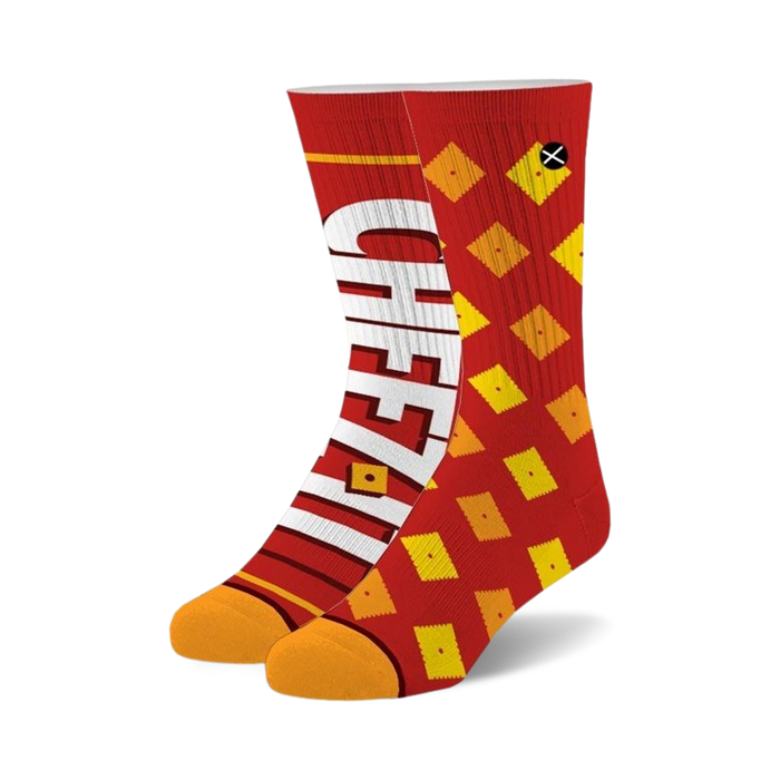 Pair of crew socks in red and orange. One sock features the Cheez-It logo, the other has a Cheez-It cracker pattern.