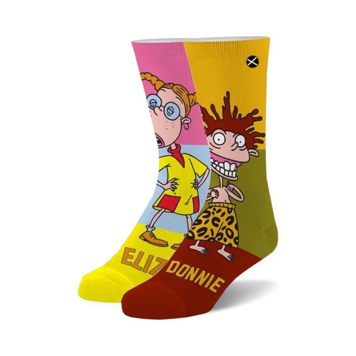 Pair of crew socks featuring Eliza and Donnie from Rugrats in pink, yellow, and green color blocks. The socks have the characters' names written on the bottom. }}