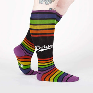 Lifestyle shot of a person wearing the rainbow striped knee-high socks.